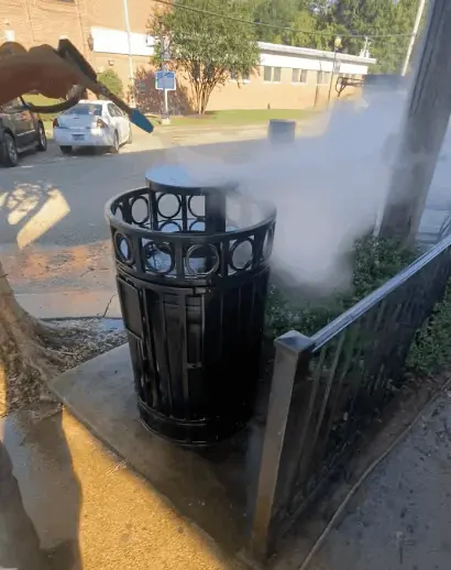 Pressure washing restaurant trash can